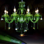 Clérachic eight-arm green glass chandelier with faceted crystal drops and chain swags, glowing against a dark night backdrop.