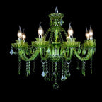 Clérachic eight-arm green glass chandelier with silver-tone fittings and hanging crystal drops, lit against a black backdrop.