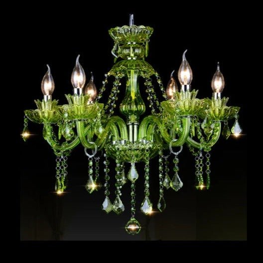 Clérachic six-arm green glass chandelier with candle bulbs and faceted crystal drops, lit against a black backdrop.
