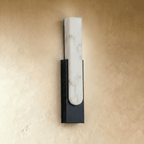 Close view of the Clérachic black-framed alabaster sconce, showing the stone panel's rounded lower edge.