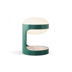 Side view of this Clérachic table lamp on white, showing the C-shaped green body that holds the dome and a flat shelf below.