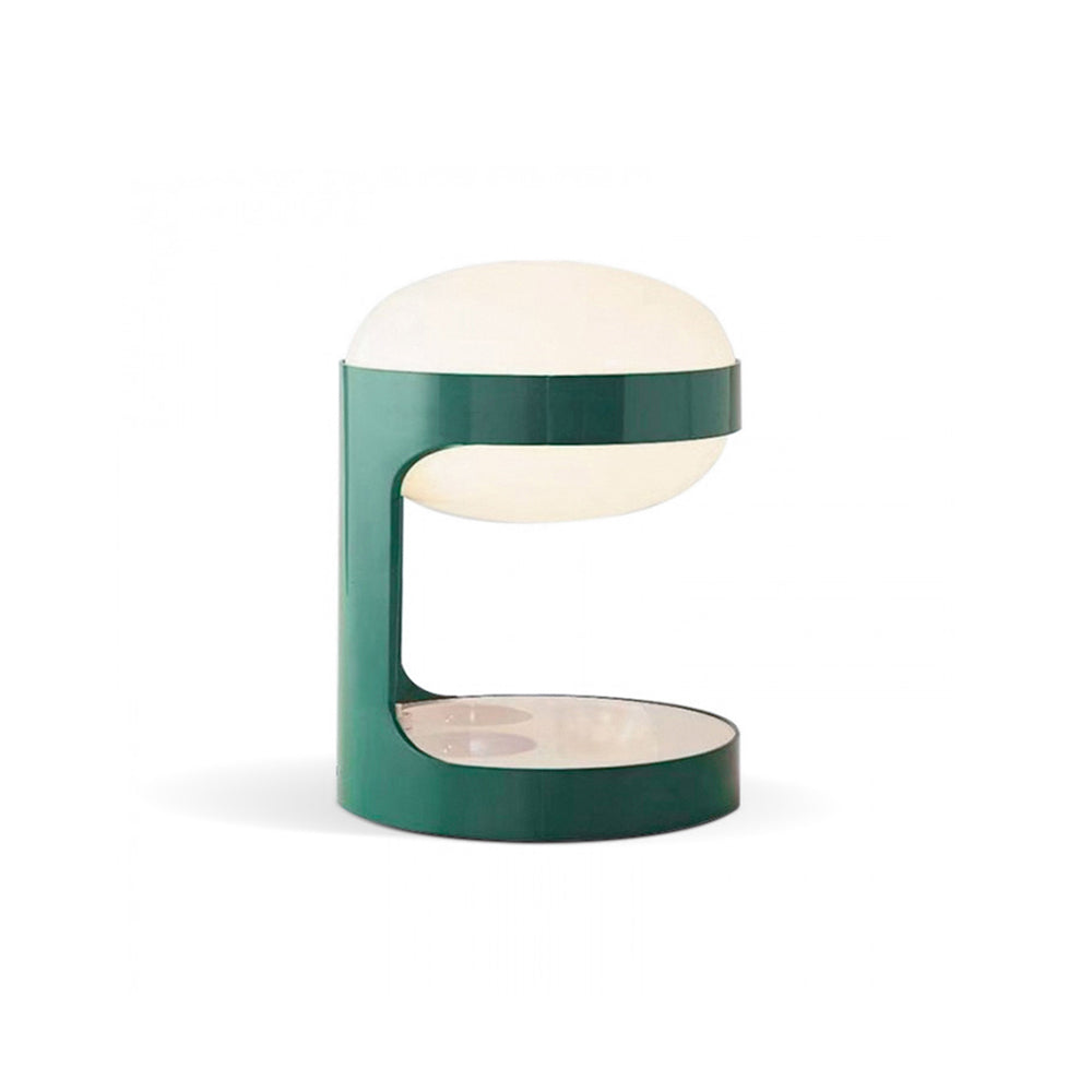 Side view of this Clérachic table lamp on white, showing the C-shaped green body that holds the dome and a flat shelf below.