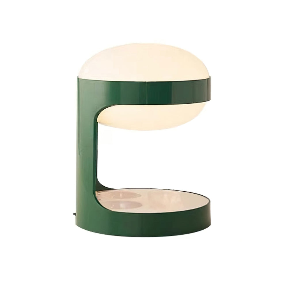 Cut-out view of this lit Clérachic table lamp, a green metal C-shape holding a glowing white dome over a reflective base.