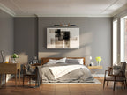 A Clérachic three-light pendant hangs centred above a bed, framed by abstract art in a warm grey bedroom.