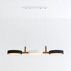 This Clérachic three-light pendant shows dark navy outer shades framing a white centre disc on white ground.