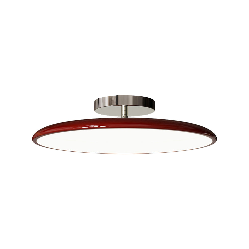 Studio shot of the Clérachic red LED disc ceiling light on a white background, showing its chrome mounting stem.