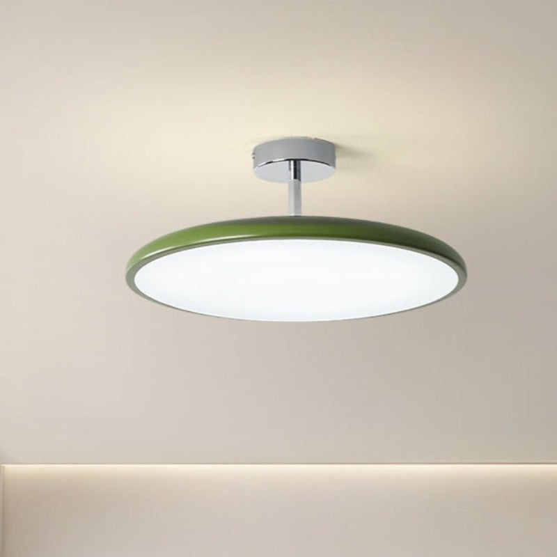 Clérachic green LED disc ceiling light shown at an angle against a plain wall, highlighting its chrome stem mount.
