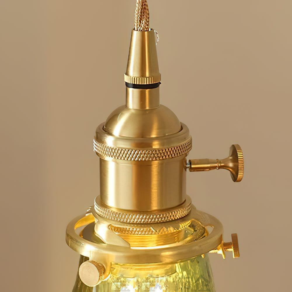 Close view of the knurled brass lamp holder and thumb screws where the cord meets the green glass on this Clérachic pendant.
