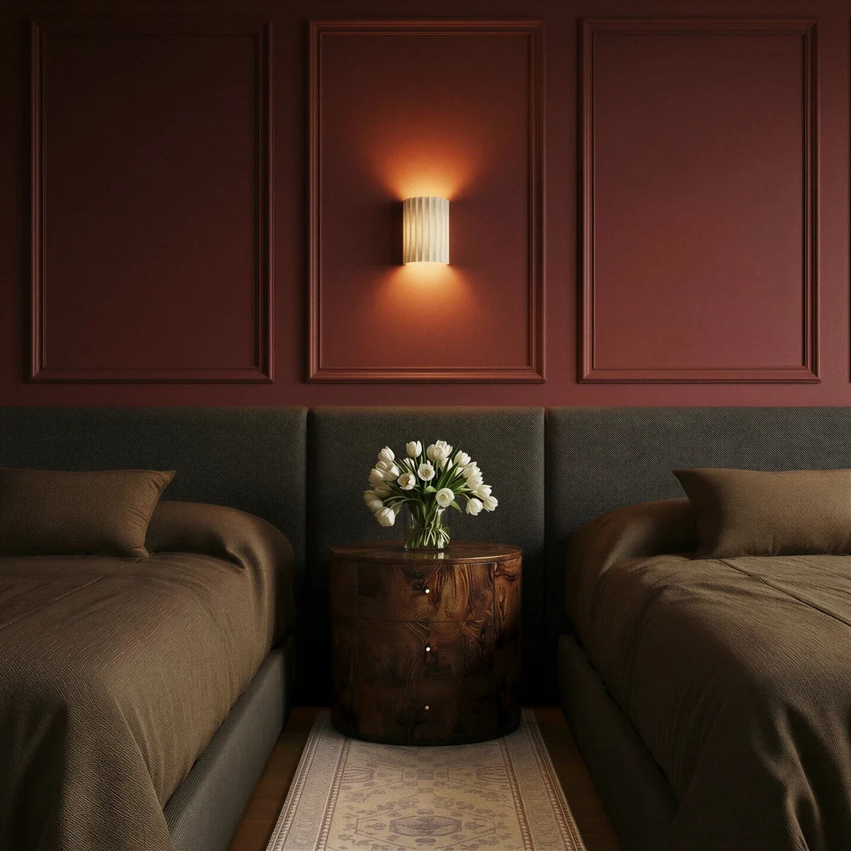 Clérachic wall lamp in white lit warm on a burgundy panelled wall between twin beds and a burl nightstand.