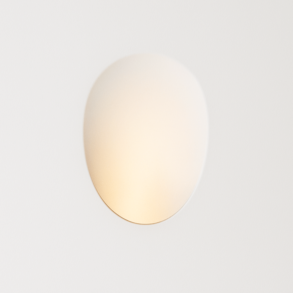 Clérachic gypsum trimless wall sconce glows softly against a plain white wall in this straight-on hero shot.