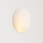 Clérachic gypsum trimless wall sconce glows softly against a plain white wall in this straight-on hero shot.