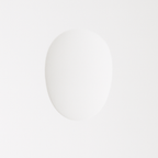 This Clérachic trimless wall sconce sits flush in white plaster, its oval light gently warming the surface.