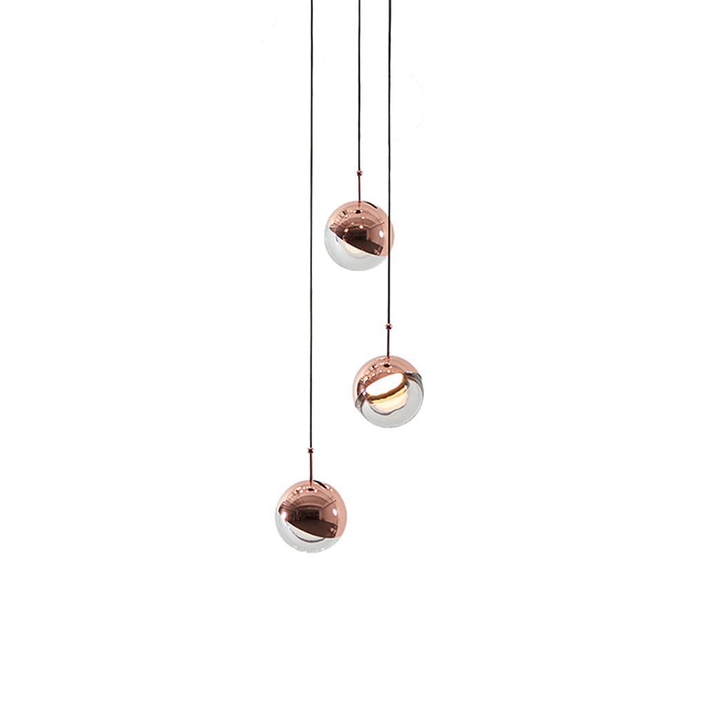 Three rose gold Clérachic globe pendants at staggered heights on thin cords, on a white backdrop.