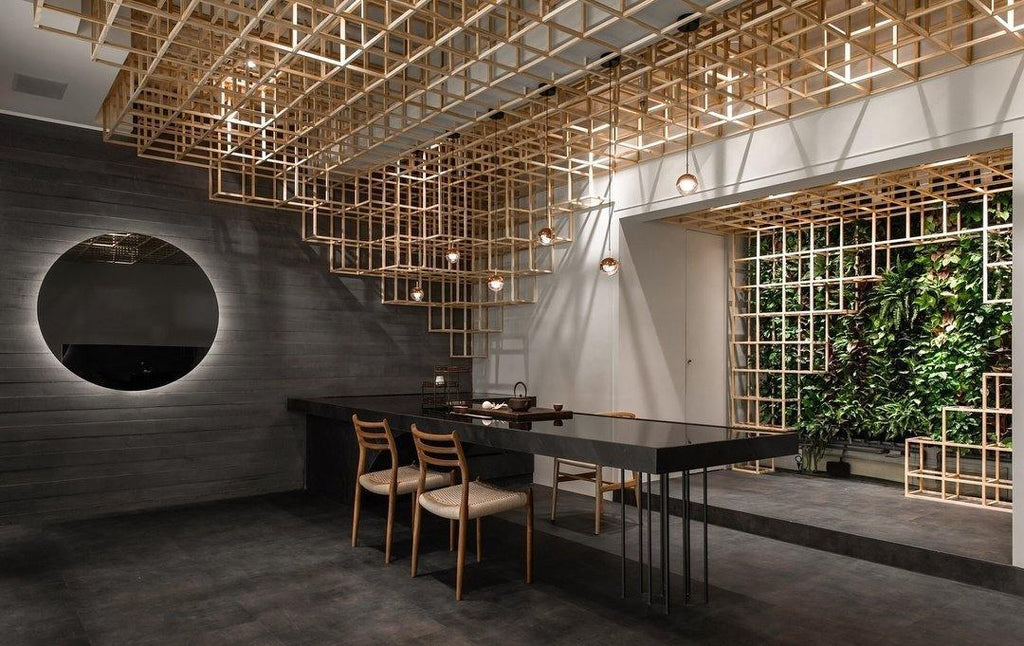 Clérachic globe pendants hung under a timber lattice ceiling, with a round backlit mirror and a green wall beyond.