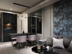 Row of Clérachic globe pendants over a black dining table with lilac chairs, beside a grey sofa and a patterned blue wall.