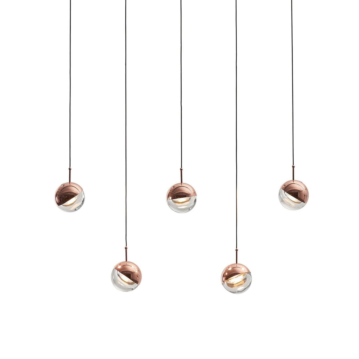 Five rose gold Clérachic globe pendants hung at staggered heights on a pale backdrop, each with a clear glass lower half.