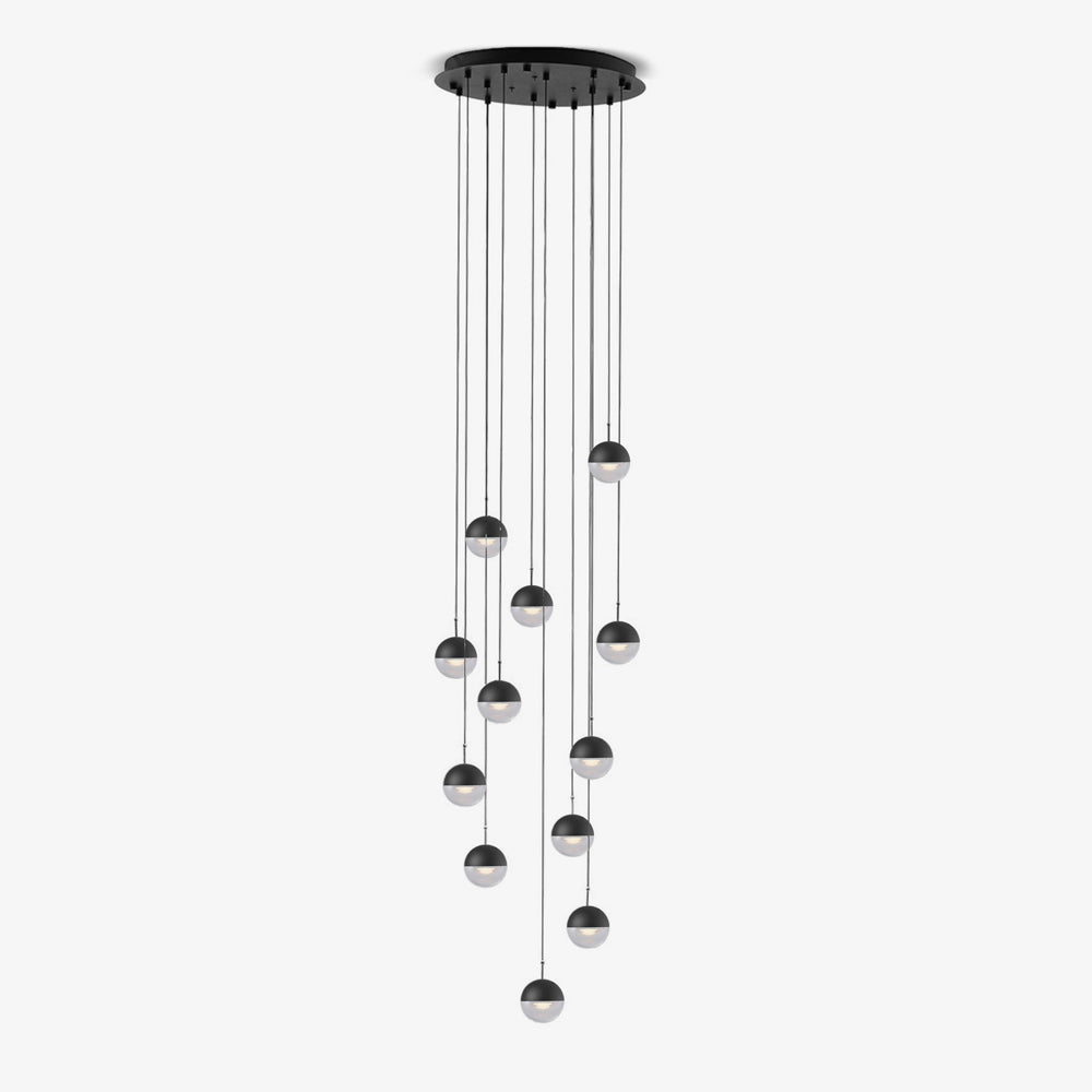 Clérachic pendant cluster with matt black caps hung at varied heights from a round black ceiling plate, on a white backdrop.