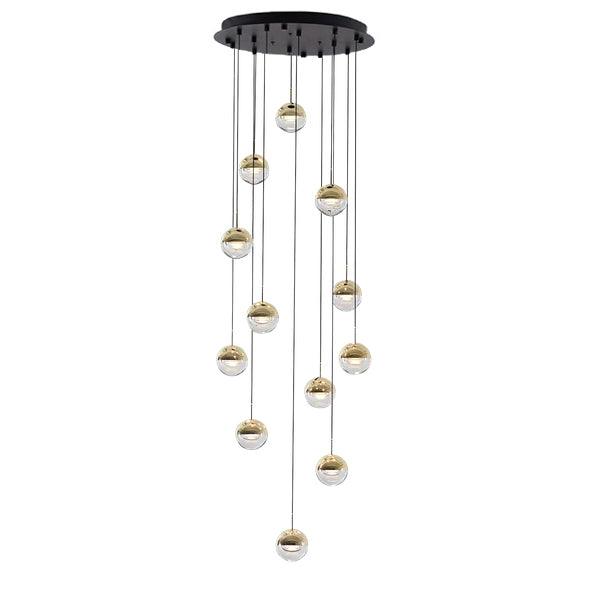 Clérachic pendant cluster with gold-finish globes hung from a round black ceiling plate, on a white backdrop.