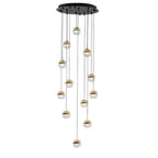Clérachic pendant cluster with gold-finish globes hung from a round black ceiling plate, on a white backdrop.