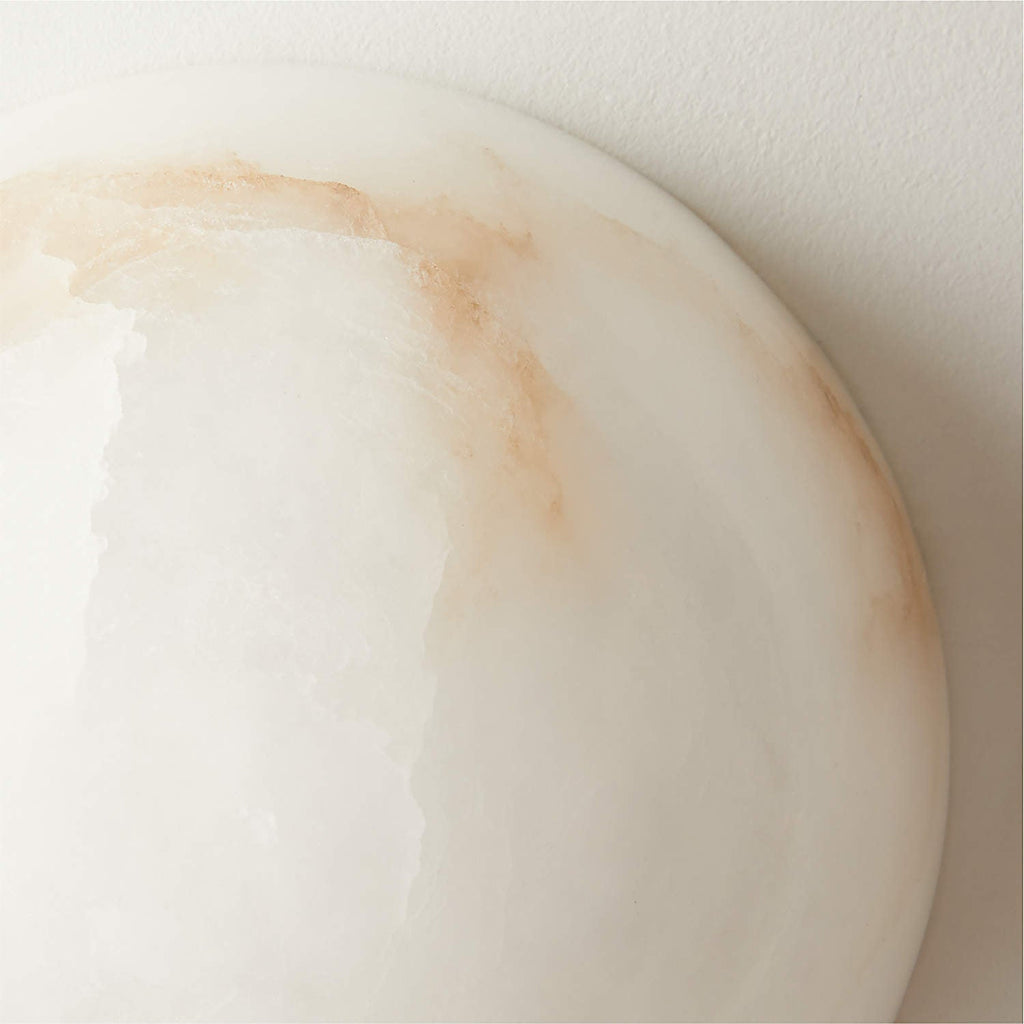 Close-up of the Clérachic Half-Dome Alabaster Wall Sconce rim, rust-toned veins running through the translucent white stone.