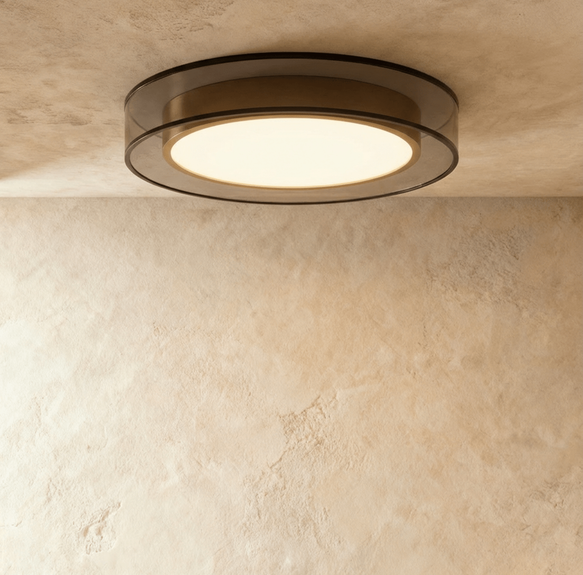 Clérachic halo ring ceiling light mounted flush, its brass-lined black ring surrounding a glowing white disc.