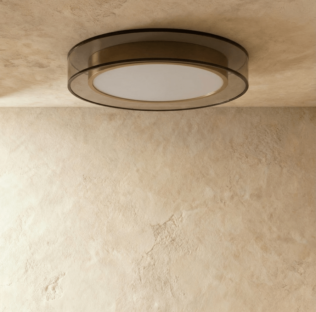 Clérachic halo ring ceiling light seen at an angle, showing the depth of its black ring and brass inner band.