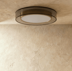 Clérachic halo ring ceiling light seen at an angle, showing the depth of its black ring and brass inner band.