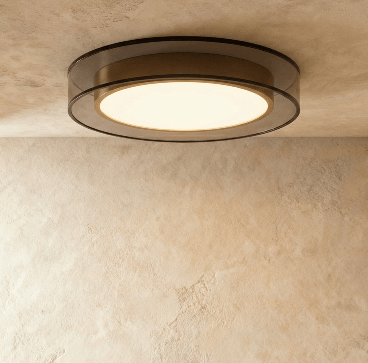 Clérachic halo ring ceiling light shown flush to the ceiling, its brass trim framing a softly lit white panel.