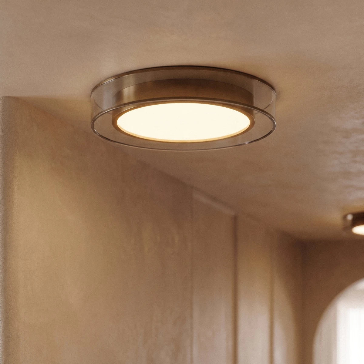 Close view of a Clérachic halo ring ceiling light glowing above a wood-paneled corridor with a second fixture beyond.