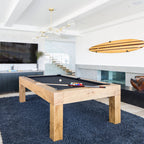 This Clérachic chandelier in gold and clear glass hangs in a bright games room above a pool table and a navy shag rug.