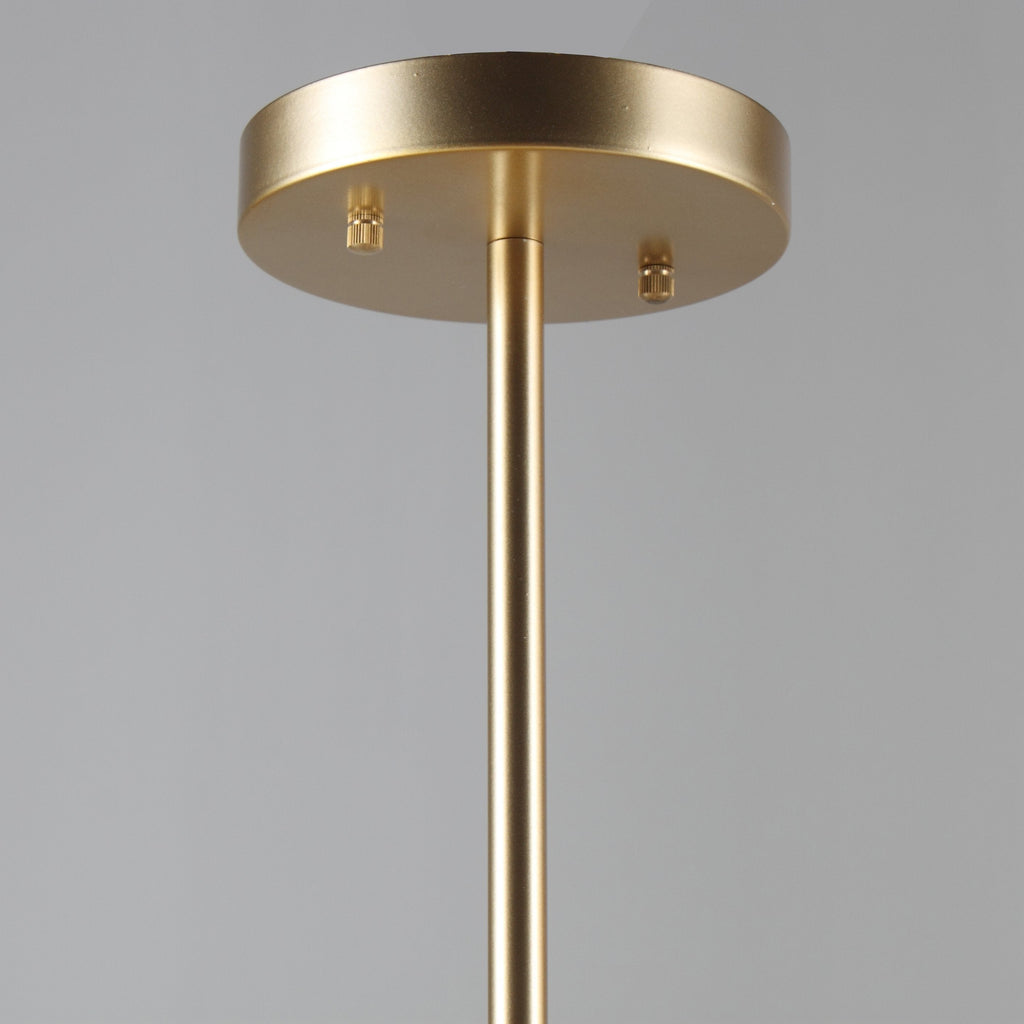 Close view of the round gold ceiling plate and slim gold rod that carry this Clérachic chandelier.