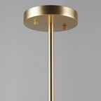 Close view of the round gold ceiling plate and slim gold rod that carry this Clérachic chandelier.