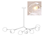Outline of the 7-head Clérachic chandelier on white, paired with a small photo of a lit clear glass globe, a second view of the same drawing.
