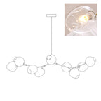 Outline of the 9-head Clérachic chandelier on white, paired with a small photo of a lit clear glass globe, a second view of the same drawing.