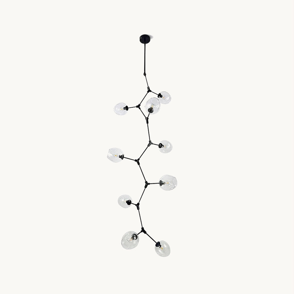 Black Clérachic vertical chandelier on a plain white backdrop, with clear glass globes on thin branching arms stepping down from a ceiling rod.