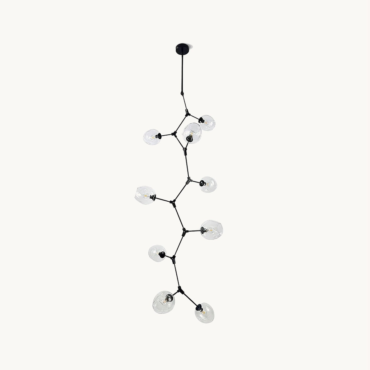 Black Clérachic vertical chandelier on a plain white backdrop, with clear glass globes on thin branching arms stepping down from a ceiling rod.