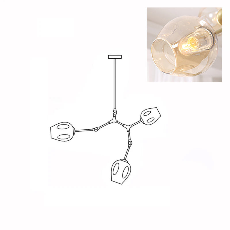 Inset close view of an amber glass globe lit from within, beside the line drawing of this Clérachic 3-head chandelier.
