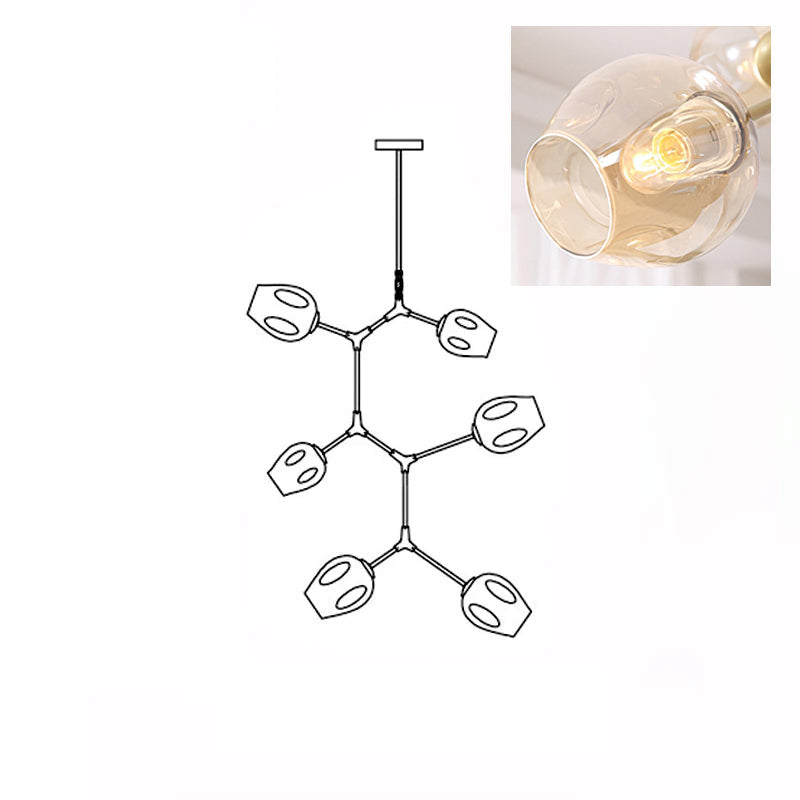 Inset close view of an amber glass globe lit from within, beside the line drawing of this Clérachic 6-head chandelier.