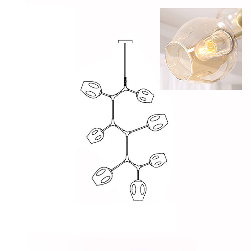 Inset close view of an amber glass globe lit from within, beside the line drawing of this Clérachic 7-head chandelier.