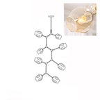 Inset close view of an amber glass globe lit from within, beside the line drawing of this Clérachic 8-head chandelier.