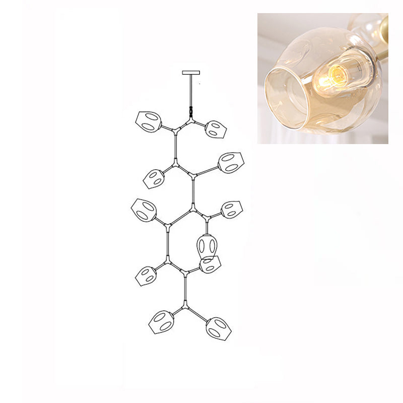 Inset close view of an amber glass globe lit from within, beside the line drawing of this Clérachic 11-head chandelier.
