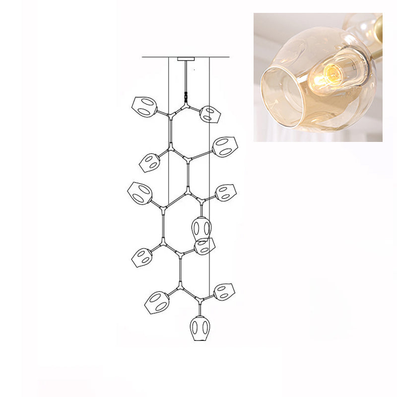 Inset close view of an amber glass globe lit from within, beside the line drawing of this Clérachic 12-head chandelier.