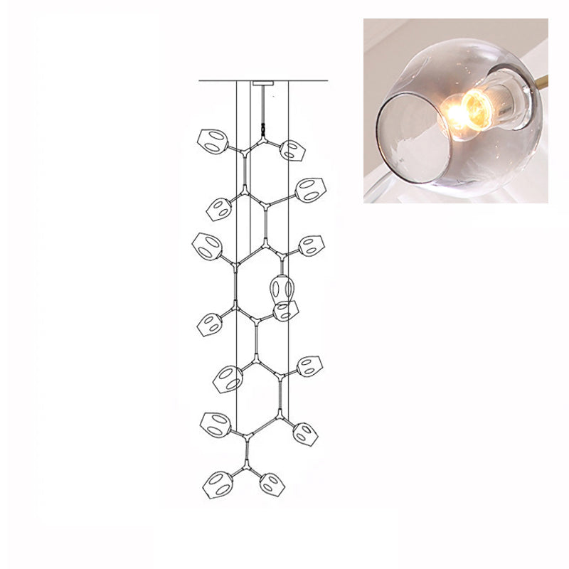 A lit, smoky grey glass globe in a close inset, next to the outline drawing of this 15-head Clérachic chandelier.
