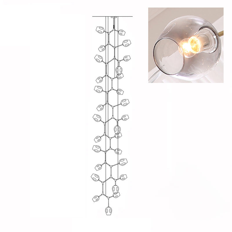 A lit, smoky grey glass globe in a close inset, next to the outline drawing of this 28-head Clérachic chandelier.