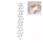A lit, smoky grey glass globe in a close inset, next to the outline drawing of this 28-head Clérachic chandelier.