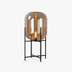 Smoked-amber glass shade on a slim black metal stand, shown on a plain white backdrop for this Clérachic table lamp.
