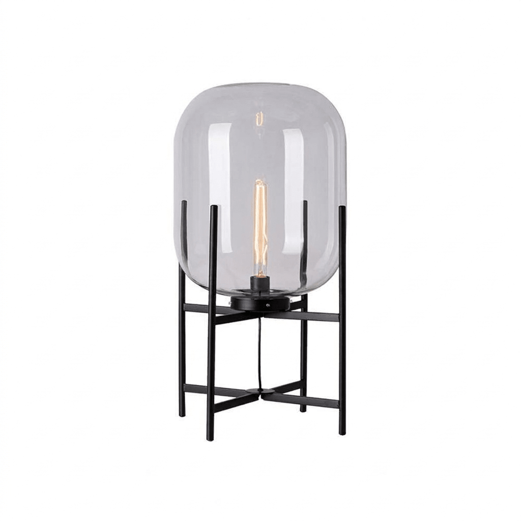 Clear glass shade with a long filament bulb on a black four-leg frame, shown on a plain white background for this Clérachic lamp.