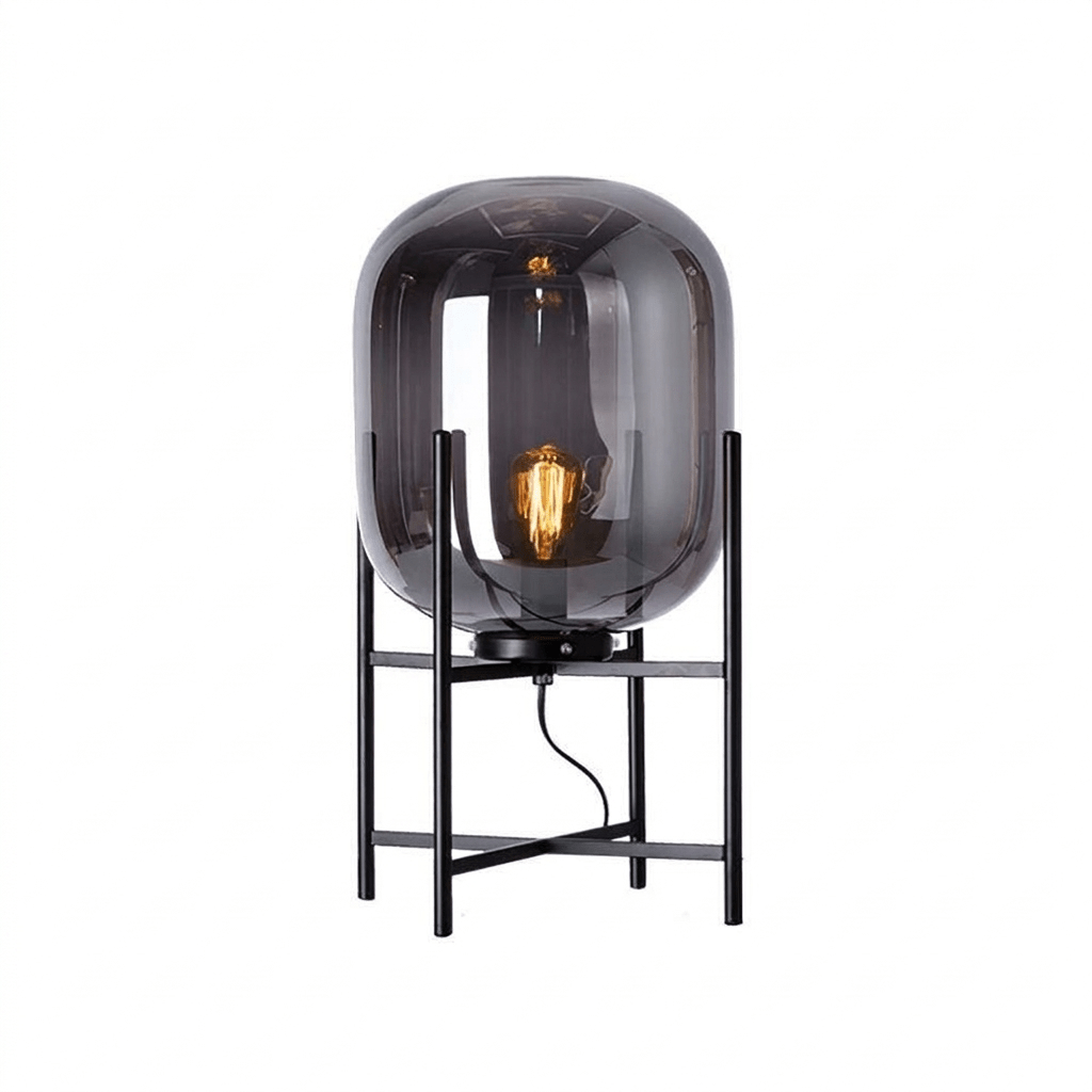 Dark smoked glass shade with a glowing filament bulb on a black four-leg stand, on a plain white background, from Clérachic.