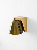 Three-quarter view of the green glass shade with its row of black studs, and a gold bracket at the top; from Clérachic.