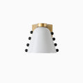 The white glass version with a brushed gold bracket and four black studs on each side, on a white backdrop; a Clérachic wall sconce.